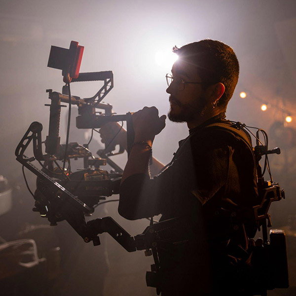 Film camera operator balancing a shot