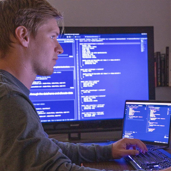 Developer writing code on a workstation